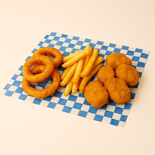 Golden onion rings, fries, and chicken nuggets arranged on blue and white checkered paper against a neutral background.